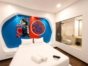 a bedroom with a large white bed and a bathroom at Cosset - A Boutique Hotel in Lonavala +17 photos