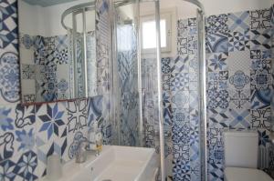 a blue and white bathroom with a sink and a mirror at Avra Pension in Ios Chora +94 photos