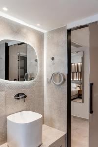 a bathroom with a white sink and a mirror at Margarita Sea Side Hotel in Kallithea Halkidikis +63 photos