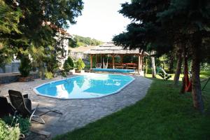 a swimming pool in a yard with a gazebo at Sokolovic STD in Lapotince