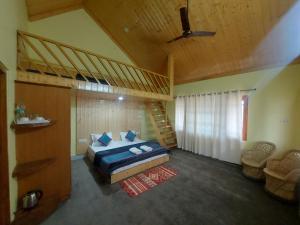 a bedroom with a bunk bed and a staircase at Shiva cottage in Kullu Manali