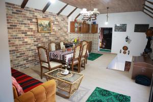 a living room with a table and a brick wall at Sokolovic STD in Lapotince