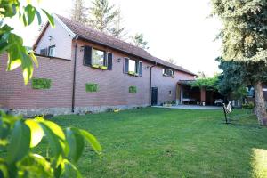 a house with a grass yard in front of it at Sokolovic STD in Lapotince