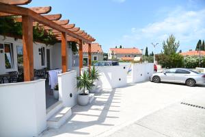 a car parked in a parking lot with a white fence at Casa De Hijos - Spacious 5 in Cavtat