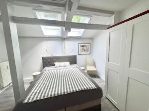 a bedroom with a bed in a room with a window at Brauhaus Suite 19 in Sebnitz