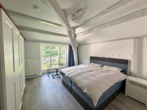 a bedroom with a large bed and a window at Brauhaus Suite 19 in Sebnitz +22 photos