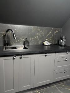 a kitchen with a sink and a counter at Moonlight jacuzzi in Stargard