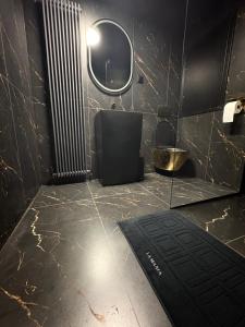 a bathroom with a black marble floor and a window at Moonlight jacuzzi in Stargard +13 photos