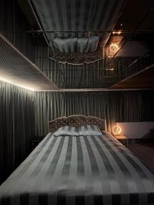 a bedroom with a large bed in a room with curtains at Moonlight jacuzzi in Stargard
