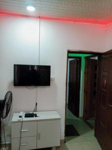 a living room with a tv on the wall and a door at Light house hotel lekki phase 1 in Araromi