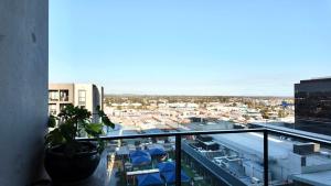 a view of a city from the balcony of a building at Premium Twin King Ensuites apartment with Double Sofa Bed at M-city Apartment Complex - Infinite Mountain View - Monash Uni & Hospital Clayton, 3168, Victoria, Australia - Free parking, Wifi, Amenities, Tea and Coffee in Clayton North