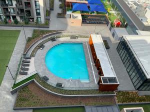 an overhead view of a swimming pool on a building at Premium Twin King Ensuites apartment with Double Sofa Bed at M-city Apartment Complex - Infinite Mountain View - Monash Uni & Hospital Clayton, 3168, Victoria, Australia - Free parking, Wifi, Amenities, Tea and Coffee in Clayton North