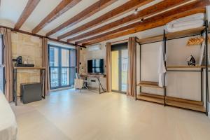 a large room with wooden ceilings and windows at Hotel Boutique Porta Ferrisa in Alicante