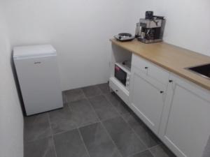 a kitchen with a counter and a white refrigerator at Tomić in Rutevac +7 photos