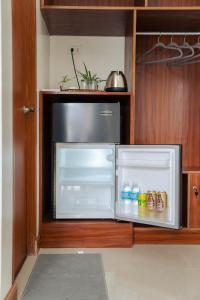 an open refrigerator with its door open in a kitchen at Casa Lucia Resort Hotel in Oslob +14 photos