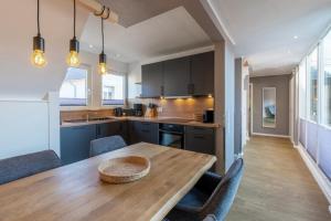 a kitchen with a wooden table and some chairs at Wohnung K13 in Borkum