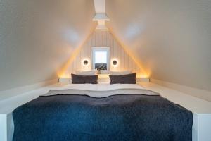 a bedroom with a large bed in a attic at Wohnung K13 in Borkum +4 photos