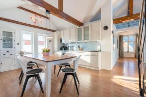a kitchen with a wooden table and chairs at Wohnung Strand Vier in Borkum
