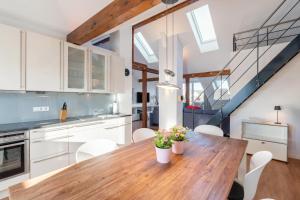 a kitchen and dining room with a wooden table and chairs at Wohnung Strand Vier in Borkum +10 photos