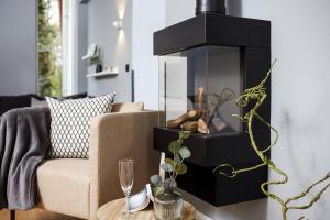 a living room with a couch and a fireplace at Ferienwohnung 1 K20 in Borkum