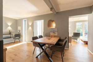 a dining room with a wooden table and chairs at Ferienwohnung 1 K20 in Borkum