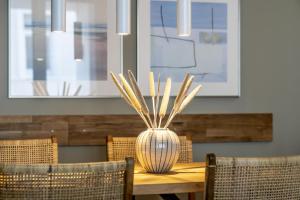 a wooden table with a vase on top of it at InselLoft Wohnung 1 in Borkum