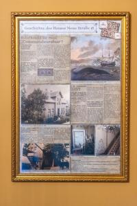 a framed picture of a house on a wall at Commandeur-Huus Wohnung 2 in Borkum +7 photos