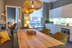 a kitchen and dining room with a wooden table at Ferienwohnung Eilert in Borkum