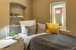 a bedroom with a bed with pillows and a window at Ferienwohnung Eilert in Borkum