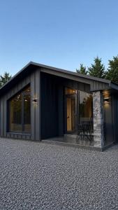 a black house with a table in front of it at Forest Solotvyno in Solotvyno