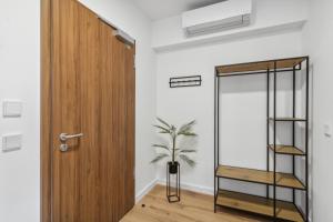 a room with a wooden door and a potted plant at Serviced Apartments Dietzenbach in Dietzenbach