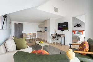 a living room with a couch and a room with a bed at Micklegate by Supercity Aparthotels in York