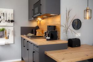 a kitchen with a counter with a coffee maker on it at Ferienwohnung Villa Central - Lüttje Nüst in Borkum