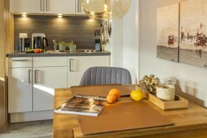 a kitchen with a wooden table with fruit on it at Pier17 Appartement 4 in Borkum +7 photos