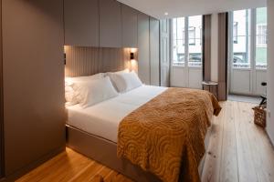 a bedroom with a large bed with white pillows at Darm in Lamego