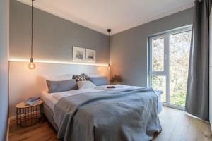 a bedroom with a large bed and a window at Ferienwohnung 2 K20 in Borkum