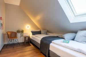a bedroom with a bed and a skylight at Haus Tidehuus in Borkum