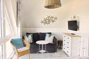 a living room with a couch and a table at Seestern in Neuenkirchen auf Rugen