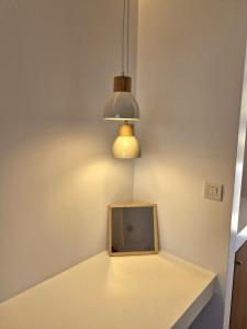 a room with a table with a tv and a light at Villa Maniati Chrissi Ammos in Agios Petros