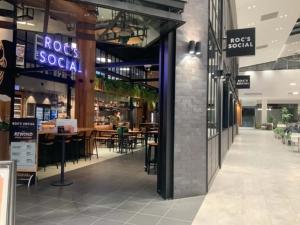 a restaurant with tables and chairs in a building at Premium Twin King Ensuites apartment with Double Sofa Bed at M-city Apartment Complex - Infinite Mountain View - Monash Uni & Hospital Clayton, 3168, Victoria, Australia - Free parking, Wifi, Amenities, Tea and Coffee in Clayton North