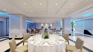 a dining room with a white table and chairs at Hotel Andalucía Center in Granada +57 photos