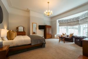 a bedroom with a bed and a living room at Farington Lodge Hotel in Preston