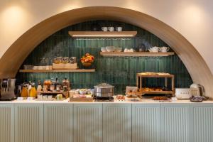 a buffet of food on a counter in a room at Hotel La Tonkine ex Olympia in Beausoleil