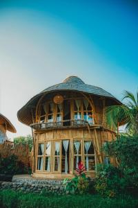 a large wooden house with a round roof at Green Lander Ubud in Ubud