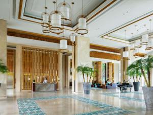 a lobby of a hotel with palm trees at Mövenpick Resort Cam Ranh in Cam Ranh +233 photos