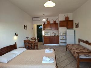 a living room with two beds and a kitchen at Valeta Studios in Armenistis +36 photos