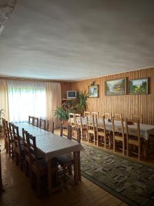 a dining room with a long table and chairs at River Side Retreat in Slavske