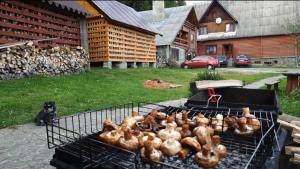 a bunch of chickens are cooking on a grill at River Side Retreat in Slavske