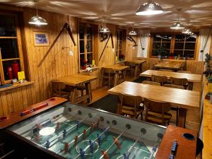 a restaurant with a pool table in the middle of a room at Horský hotel Portáš in Nový Hrozenkov