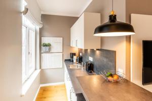 a kitchen with a counter with a bowl of fruit at Logierhaus K15 Appartement 5 in Borkum